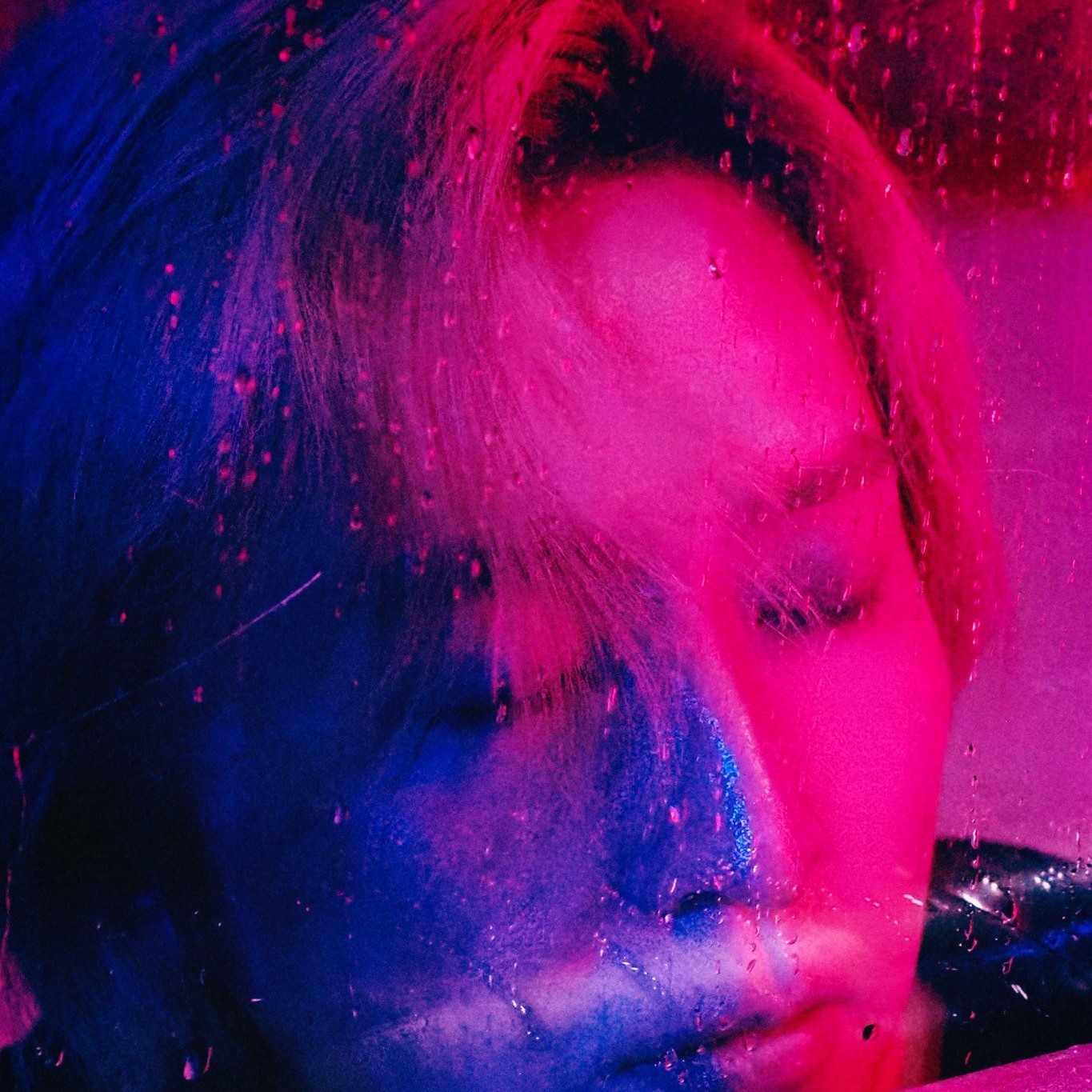 Cheney Yang in magenta and blue lighting